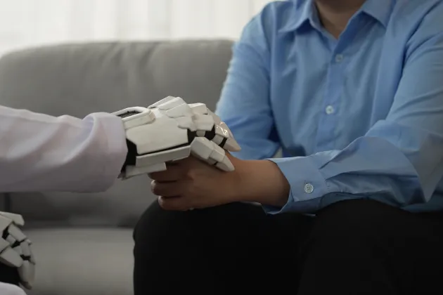 robot holding hand with a man. photo.