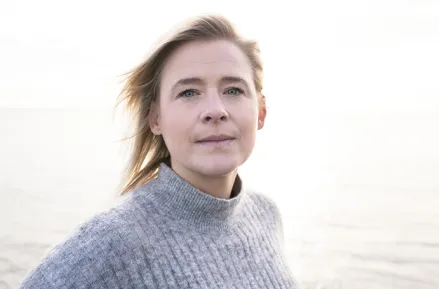 Face portrait of woman with the sea in the background. Photo.