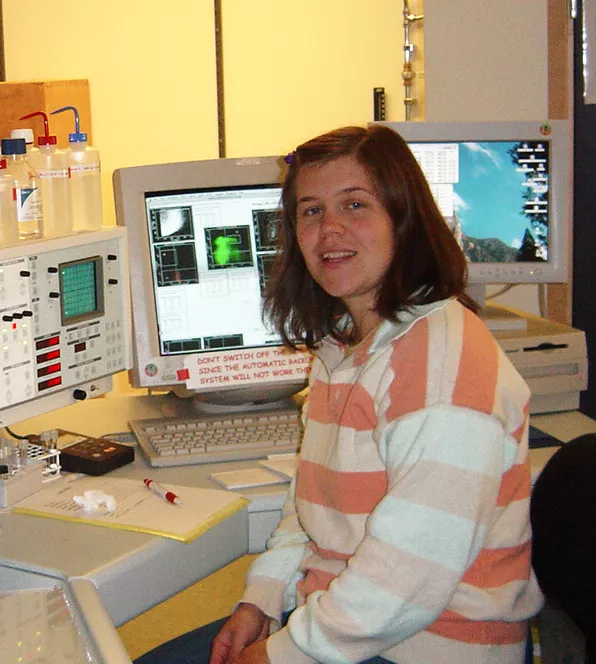 picture of Project manager Anna Fossum, in 2002, in front of FACS Vantage SE when only two instruments could fit in the lab. photo.